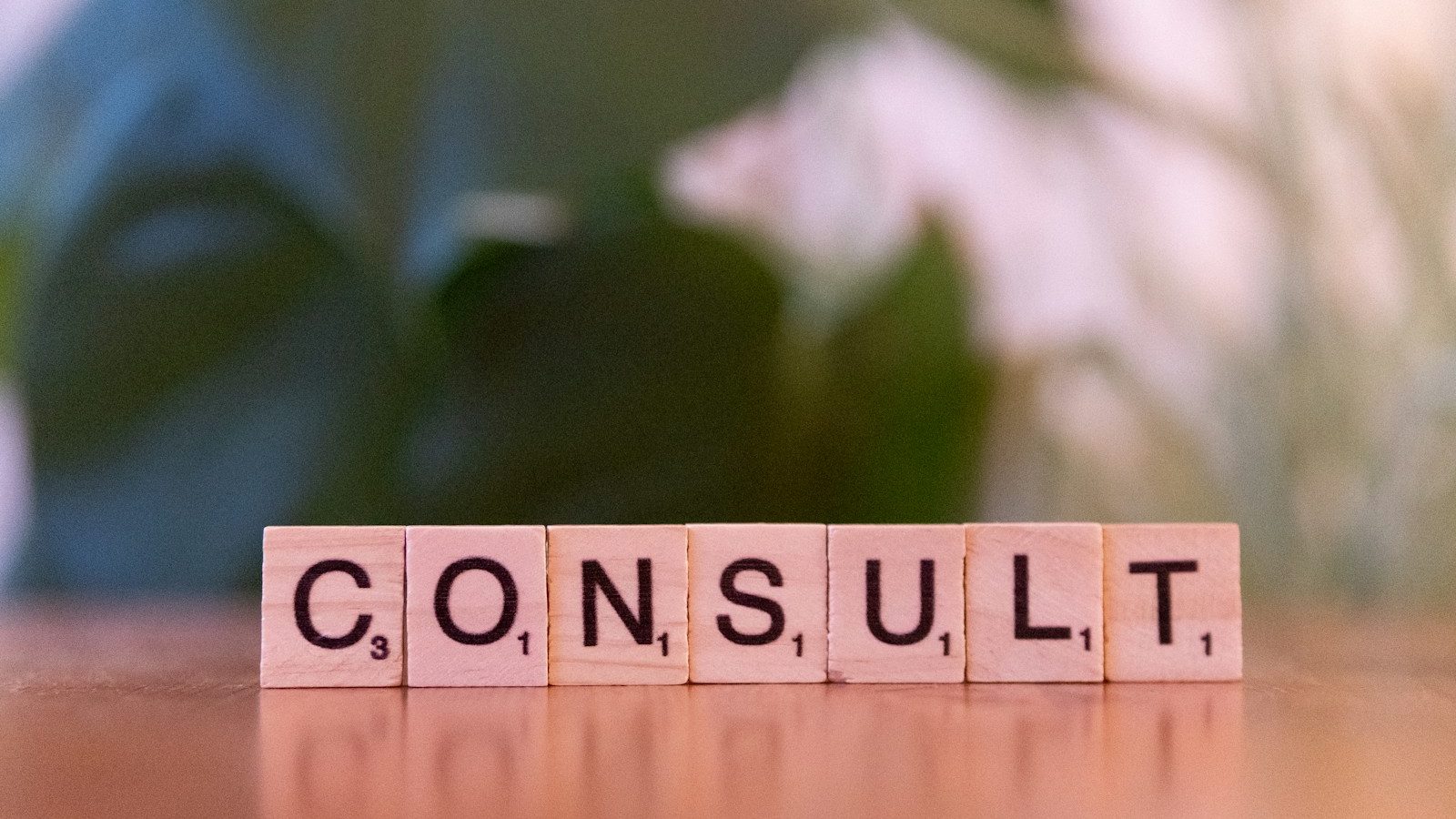 A wooden block spelling consulting on a table